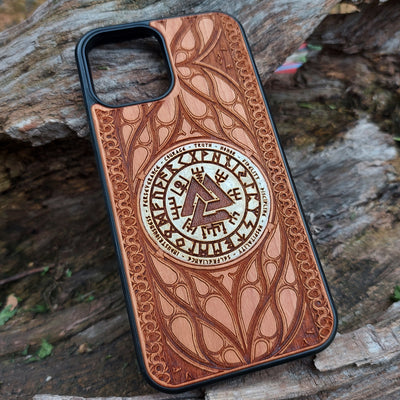 Nordic-inspired wooden phone case featuring a Valknut symbol surrounded by runic designs, precision-engraved for a bold and meaningful statement. This protective case is a perfect fit for iPhone , 15, 14, 13, 12, 11, Pro Max, Mini, and Samsung Galaxy S, S24, S23, S22, S21, S20 Ultra, Plus, Note 20. Ideal for those who admire Norse mythology and elegant craftsmanship.