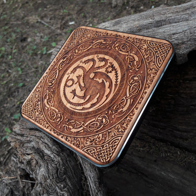 Dark wood wireless charger featuring Westeros house designs.
