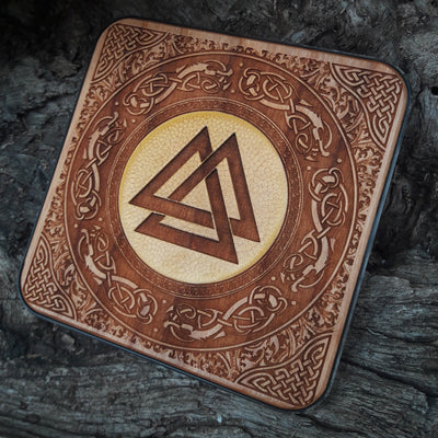 Artisan wood charger with hand-painted Viking designs.