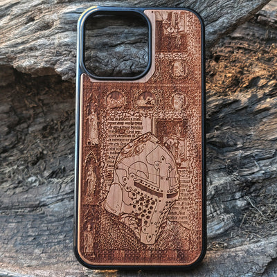 Intricately carved wooden phone case featuring a medieval knight helmet and gothic designs. Handcrafted for iPhone  and Galaxy S users, perfect for fans of history and medieval art.