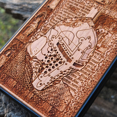 Intricately carved wooden phone case featuring a medieval knight helmet and gothic designs. Handcrafted for iPhone  and Galaxy S users, perfect for fans of history and medieval art.