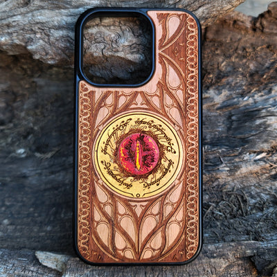 Hand-painted Lord of the Rings wood phone case featuring the Eye of Sauron with vibrant colors and laser-engraved Elvish script. Crafted with intricate detailing for durability and elegance, this case is compatible with iPhone , 15, 14, 13, 12, 11, Pro Max, Mini, and Samsung Galaxy S, S24, S23, S22, S21, S20 Ultra, Plus, Note 20. A unique and protective accessory for Tolkien fans.
