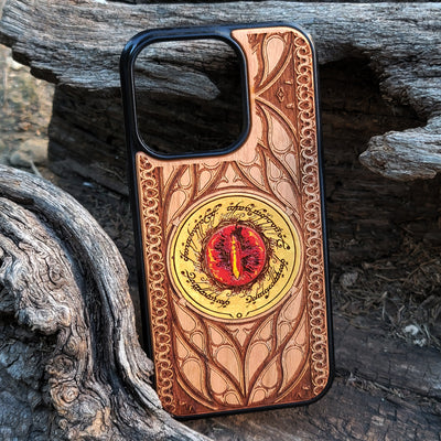 Hand-painted Lord of the Rings wood phone case featuring the Eye of Sauron with vibrant colors and laser-engraved Elvish script. Crafted with intricate detailing for durability and elegance, this case is compatible with iPhone , 15, 14, 13, 12, 11, Pro Max, Mini, and Samsung Galaxy S, S24, S23, S22, S21, S20 Ultra, Plus, Note 20. A unique and protective accessory for Tolkien fans.