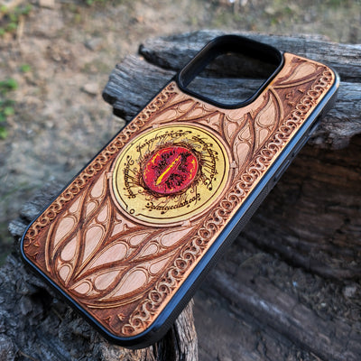 Hand-painted Lord of the Rings wood phone case featuring the Eye of Sauron with vibrant colors and laser-engraved Elvish script. Crafted with intricate detailing for durability and elegance, this case is compatible with iPhone , 15, 14, 13, 12, 11, Pro Max, Mini, and Samsung Galaxy S, S24, S23, S22, S21, S20 Ultra, Plus, Note 20. A unique and protective accessory for Tolkien fans.