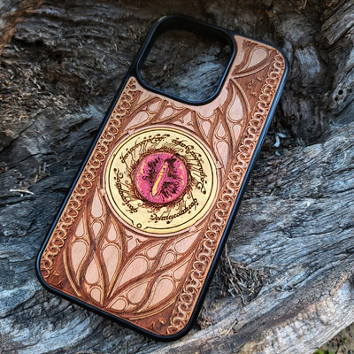 Hand-painted Lord of the Rings wood phone case featuring the Eye of Sauron with vibrant colors and laser-engraved Elvish script. Crafted with intricate detailing for durability and elegance, this case is compatible with iPhone , 15, 14, 13, 12, 11, Pro Max, Mini, and Samsung Galaxy S, S24, S23, S22, S21, S20 Ultra, Plus, Note 20. A unique and protective accessory for Tolkien fans.