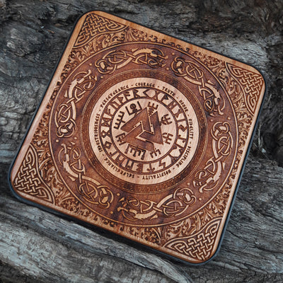 Overhead view of hand-painted Norse runes on Viking charger.